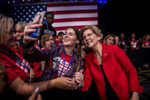 Elizabeth Warren takes a selfie with a Students Demand Action volunteer at the Gun Sense Forum. 