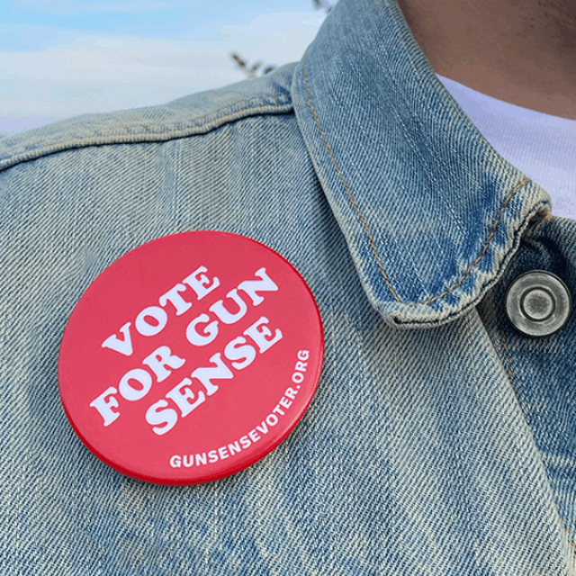 A person wearing a vote for gun sense pin