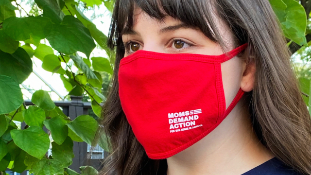 A woman wears a Moms Demand Action mask