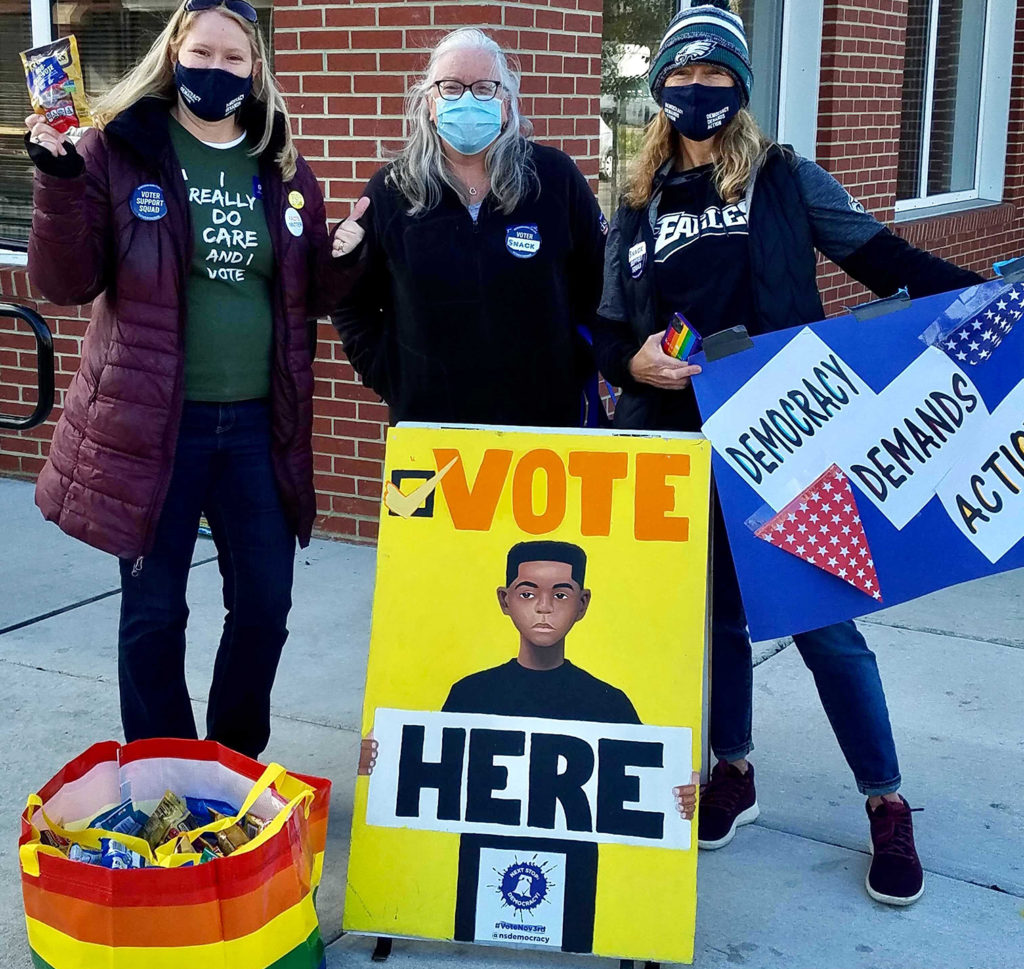 Moms Demand Action volunteers at a polling place handing out snacks and encouraging voters on election day