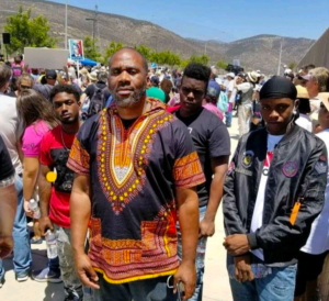 Aaron Foster stands at an event with three other men