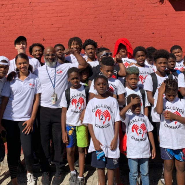 Terry ‘Uncle T’ Williams of Challenge 2 Change poses for a group photo with about 20 young people