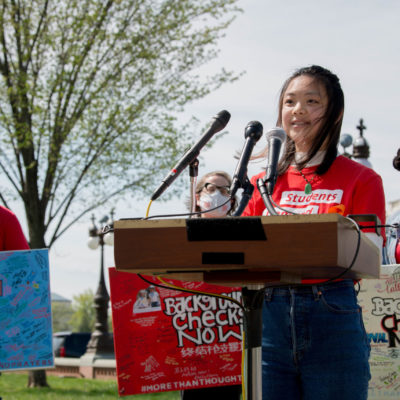Jeannie She speaks at the podium at the Road Trip for Background Checks event at the Capitol