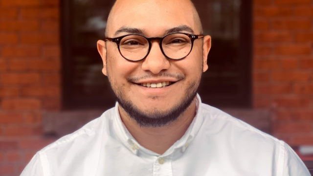 Jose Alfaro headshot. Jose smiles while wearing glasses and a button down shirt.