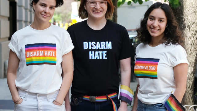 Three people wearing Disarm Hate t-shirts pose for a photo