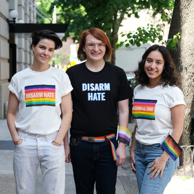 Three people wearing Disarm Hate t-shirts pose for a photo