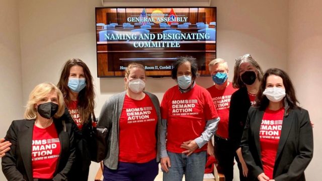 Masked Tennessee Moms Demand Action volunteers pose for a photo in their red Moms Demand Action t-shirts