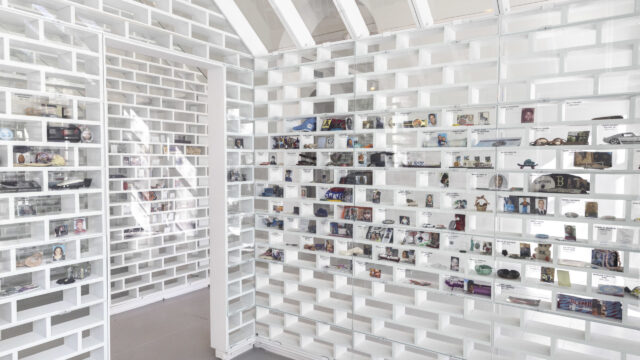 Lined up white bricks with memorial objects on display at the Gun Violence Memorial Project