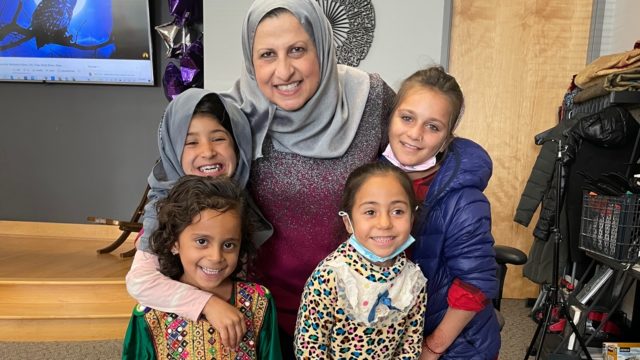 Janan Najeeb poses for a photo with children