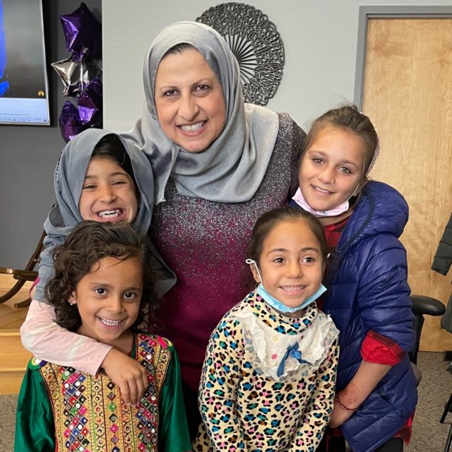 Janan Najeeb poses for a photo with children