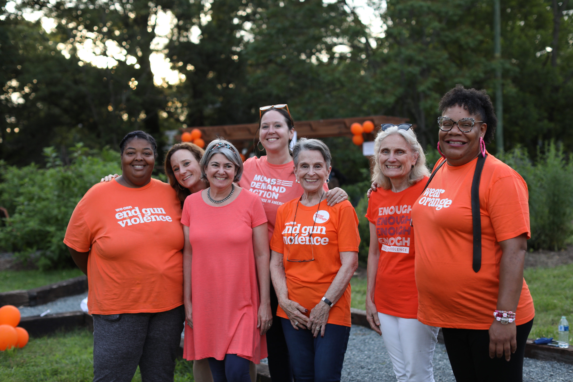 People pose for a photo wearing Wear Orange t-shirts