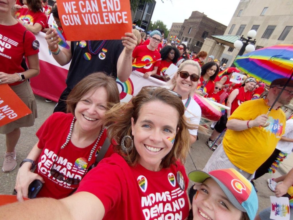 Moms Demand Action volunteers pose for a selfie at Pride