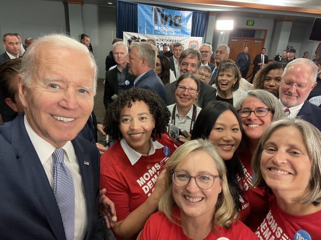 Moms Demand Action volunteers pose for a selfie with President Biden