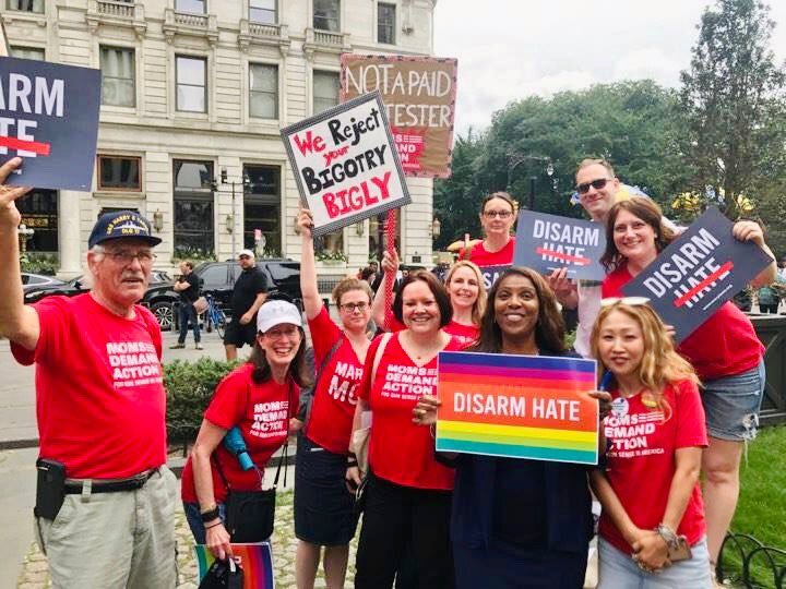Moms Demand Action volunteers hold up Disarm Hate signs