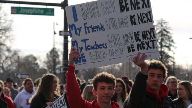 Students rallying and holding signs at Colorado Advocacy Day