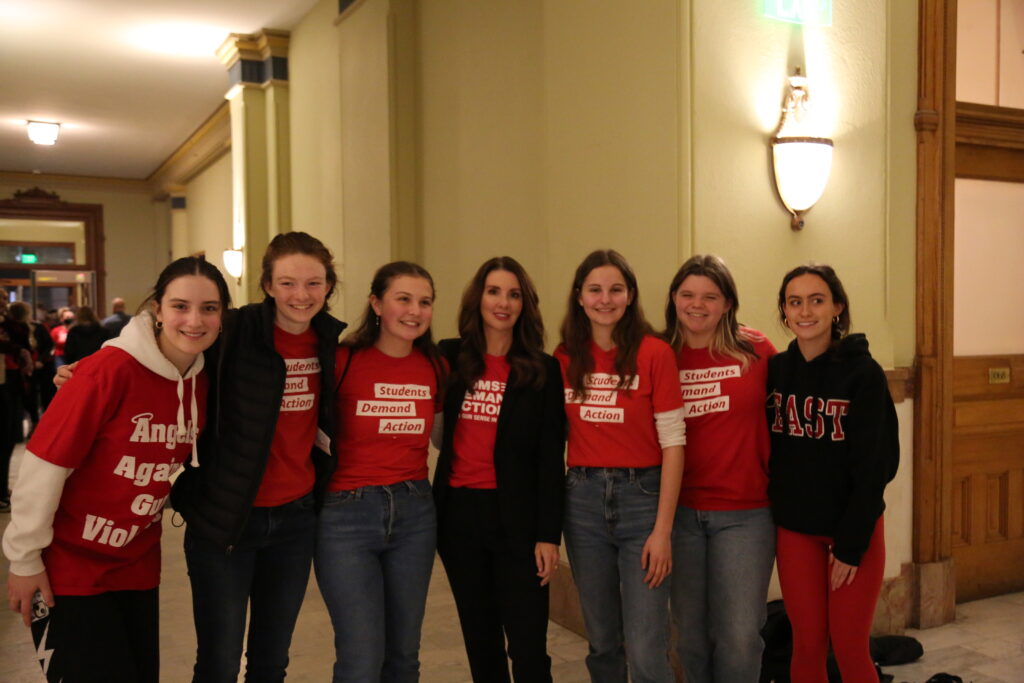 Students Demand Action volunteers pose for a photo with Moms Demand Action founder Shannon Watts