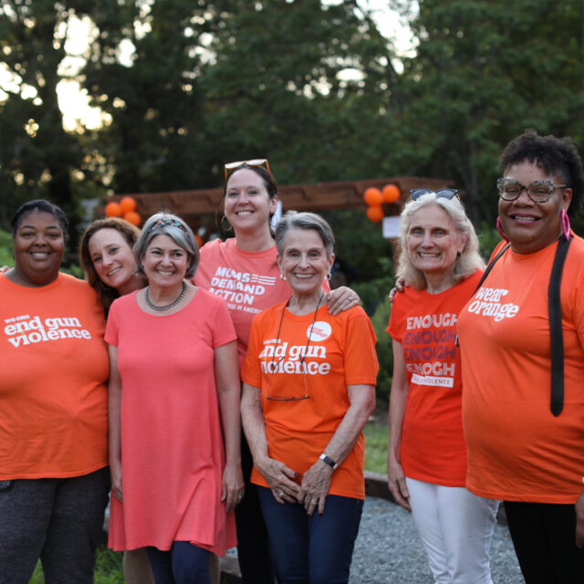 Moms Demand Action volunteers pose for a photo wearing Wear Orange t-shirts