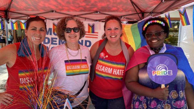 Moms Demand Action volunteers table at a Pride event