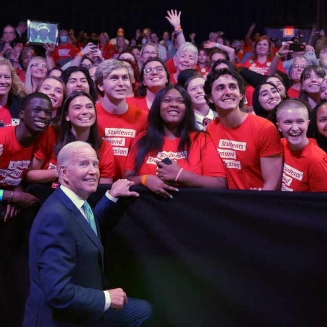 President Biden poses for a photo with Students Demand Action volunteers
