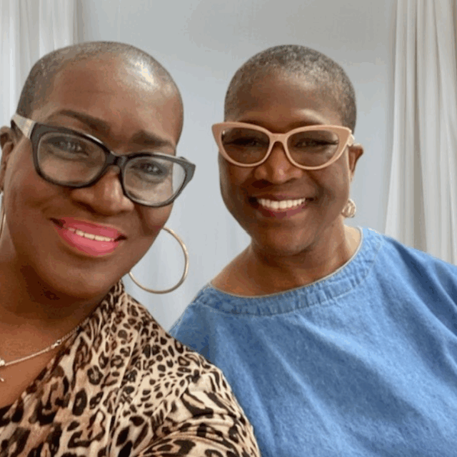 Sharon Robinson and Cynthia Duhart take a selfie together. Both wear glasses and gold jewelry.